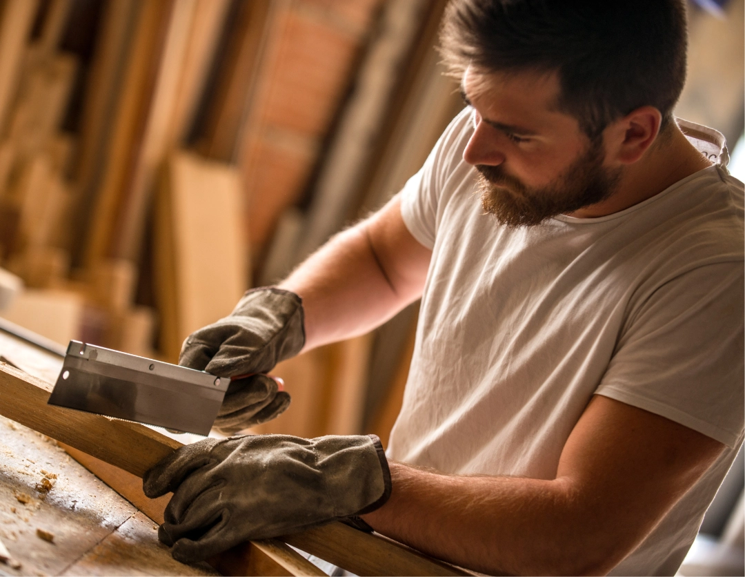 A Carpenter using a hand tool 
