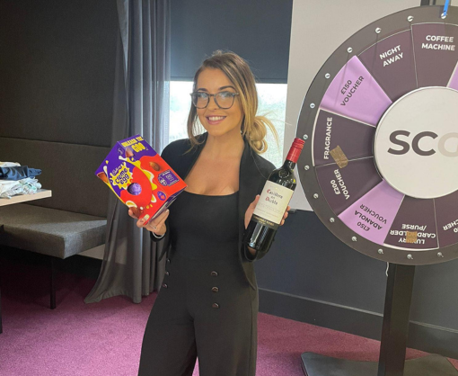 Georgia Parkinson holding an easter egg and a bottle of wine