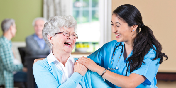 Nurse with their arm resting on an elderly patient