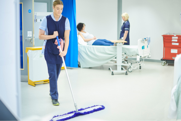 A cleaner cleaning a hospital ward