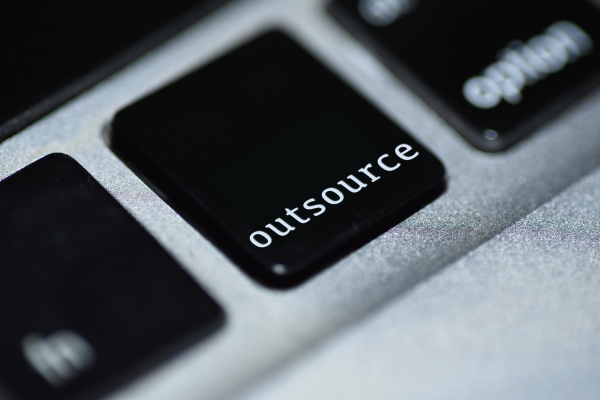 A keyboard button with the word 'outsource' on it