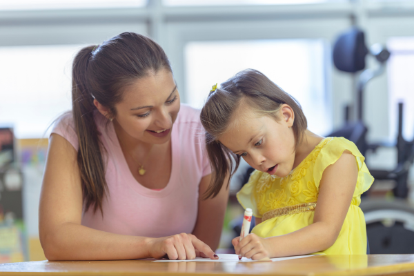A teaching professional sat with a child