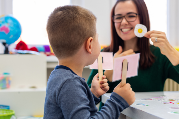 A female Speech & Language Therapist helping a young boy