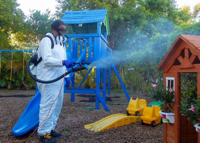 A school maintenance person cleaning a school playground